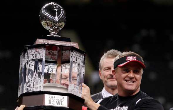 Louisiana-Lafayette head coach Mark Hudspeth celebrates a third straight New Orleans Bowl win. (AP Photo/Bill Haber)